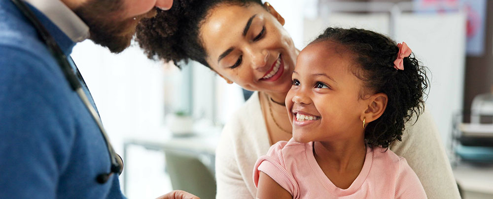 Woman and young girl smiling and looking at each other