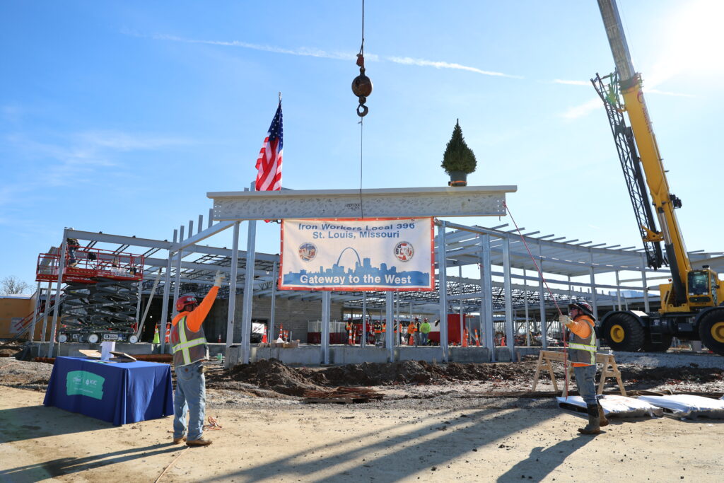 The final structural beam being placed on the new hospital
